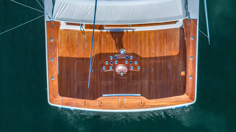 Slide: The Image of Overhead view of a 2004 Viking 2005 yacht's wooden deck on water. - 39