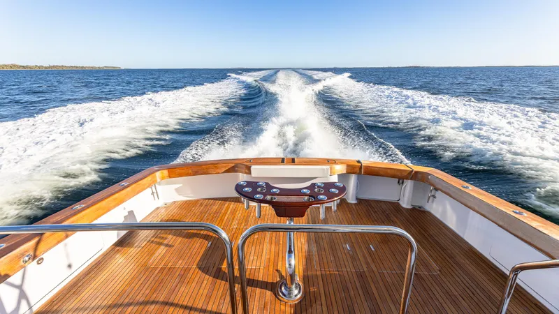 Slide: The Image of Luxury Viking 2005 boat cruising on open water, leaving a wake behind. - 49