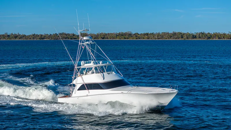 Slide: The Image of A 2004 Viking 2005 model yacht cruising on open water under a clear blue sky. - 7