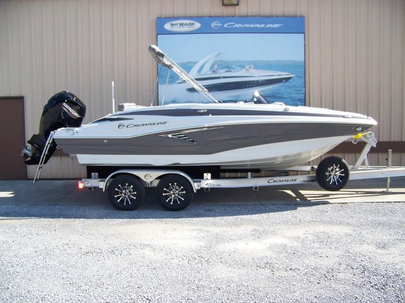 The Image of 2026 Crownline Eclipse E210 XS boat on trailer, displayed outdoors. - 1