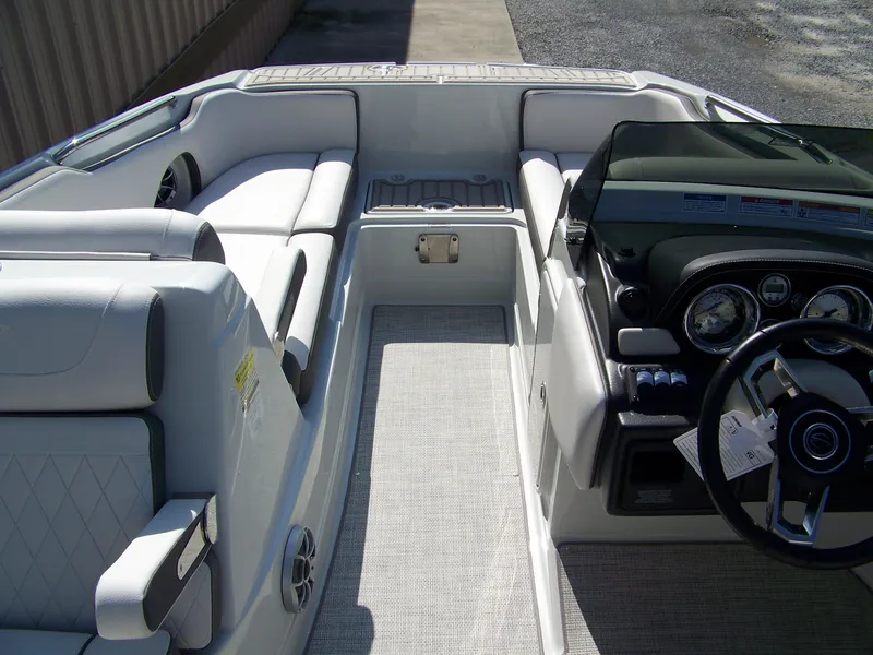 Slide: The Image of 2026 Crownline Eclipse E210 XS boat interior with modern dashboard and comfortable seating. - 12