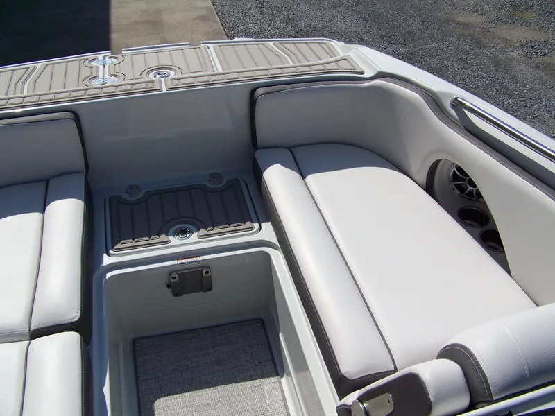 Slide: The Image of 2026 Crownline Eclipse E210 XS boat interior with cushioned seating and storage compartments. - 15