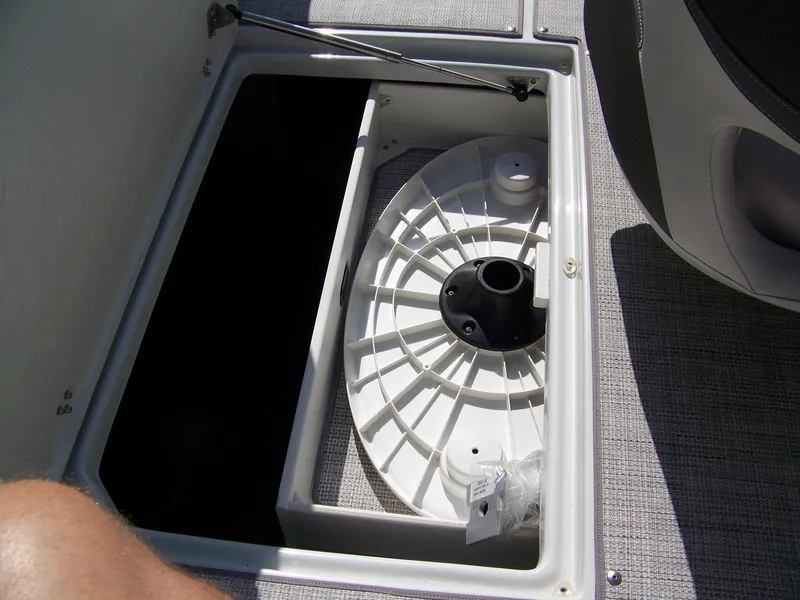 Slide: The Image of 2026 Crownline Eclipse E210 XS boat storage compartment with circular base. - 19