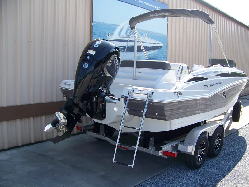 Slide: The Image of 2026 Crownline Eclipse E210 XS boat with outboard motor and trailer. - 3