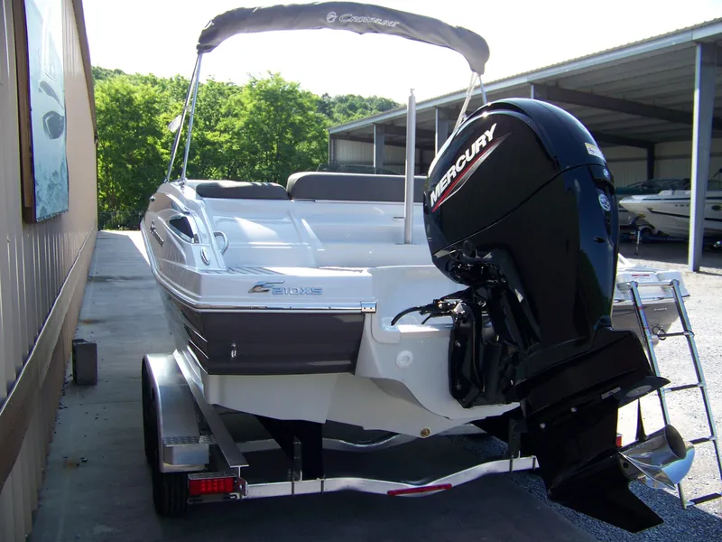 Slide: The Image of 2026 Crownline Eclipse E210 XS boat with Mercury outboard motor on a trailer. - 4