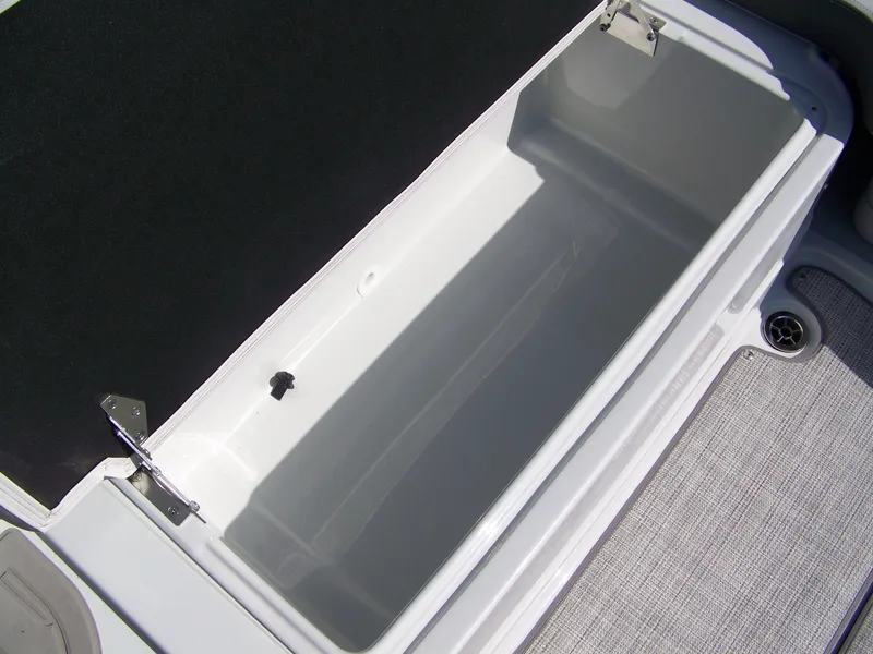 Slide: The Image of 2026 Crownline Eclipse E210 XS boat storage compartment, open and empty. - 7