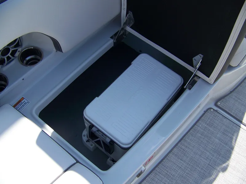 Slide: The Image of 2026 Crownline Eclipse E210 XS boat storage compartment with cooler. - 9