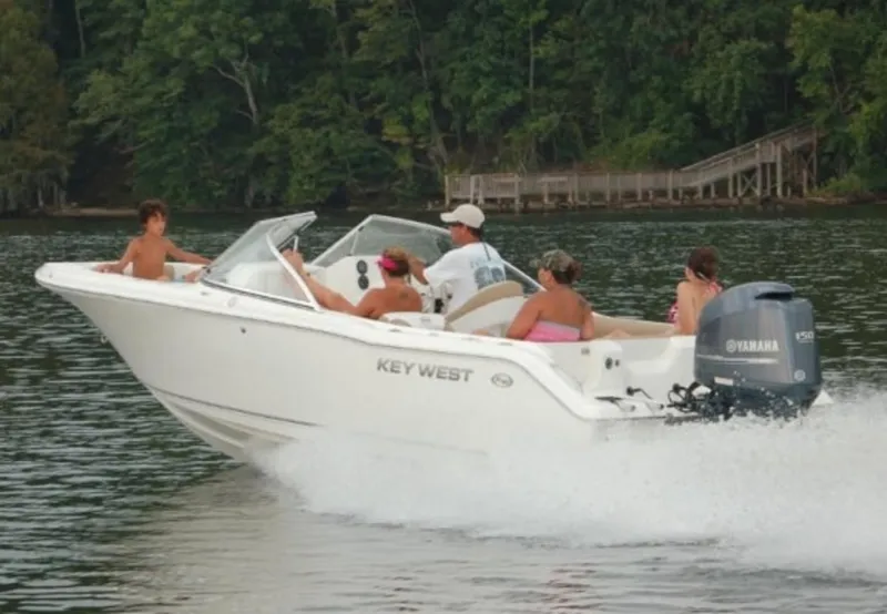 Slide: The Image of 2025 Key West 203 DFS boat cruising on a lake with passengers enjoying the ride. - 0