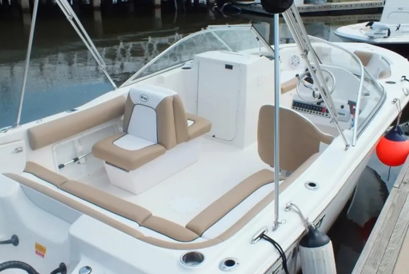 Slide: The Image of 2025 Key West 203 DFS boat interior with beige seating and modern dashboard. - 6