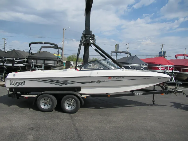 Slide: The Image of 2001 Tigé 21i/SK boat on trailer, parked outdoors under cloudy sky. - 1