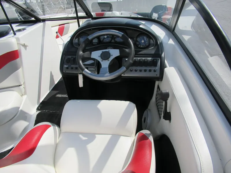 Slide: The Image of 2001 Tigé 21i/SK boat interior with steering wheel and dashboard controls. - 3