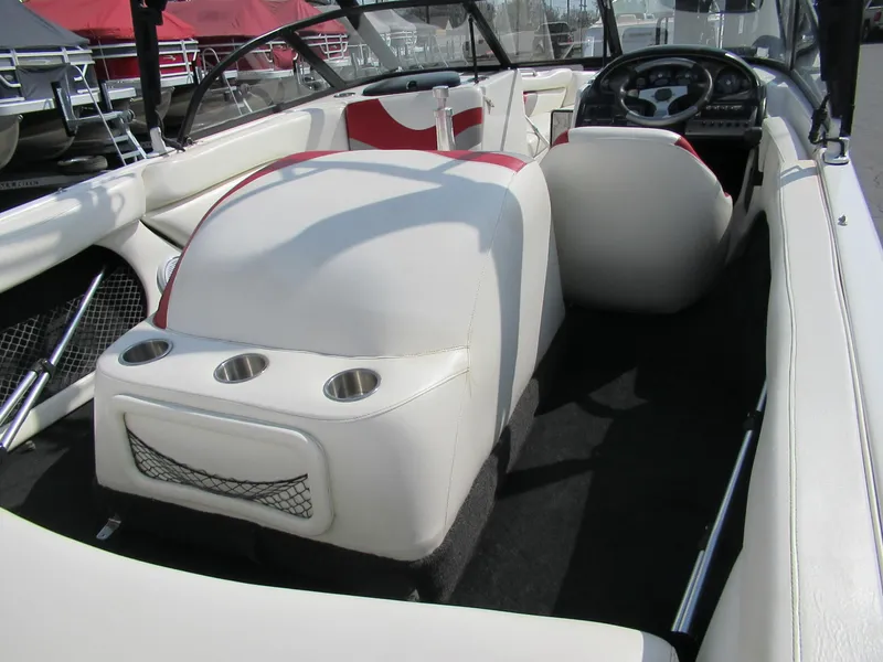 Slide: The Image of 2001 Tigé 21i/SK boat interior with white and red seating, cup holders, and steering wheel. - 5
