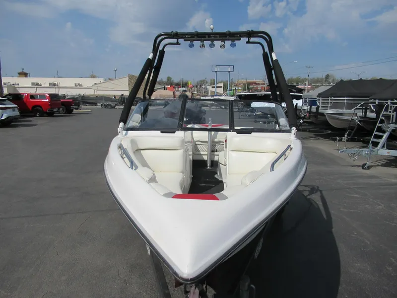 Slide: The Image of 2001 Tigé 21i/SK boat with tower, parked in a marina under a blue sky. - 6