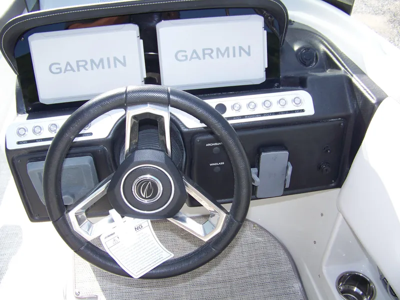 Slide: The Image of Steering wheel and dashboard of 2026 Crownline Eclipse E230 XS boat with Garmin displays. - 10
