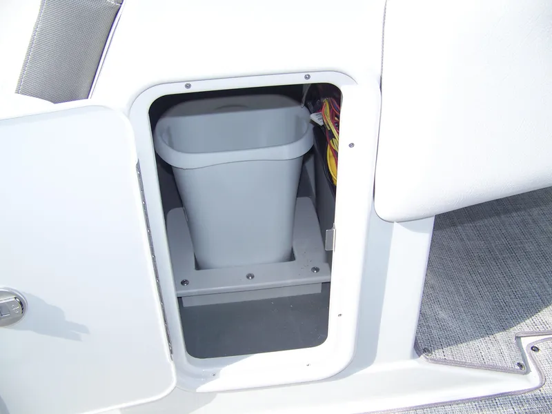 Slide: The Image of Storage compartment with trash bin in 2026 Crownline Eclipse E230 XS boat. - 16