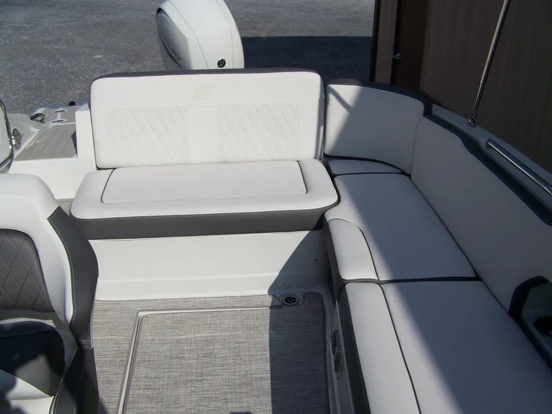 Slide: The Image of 2026 Crownline Eclipse E230 XS boat interior with white cushioned seating. - 6