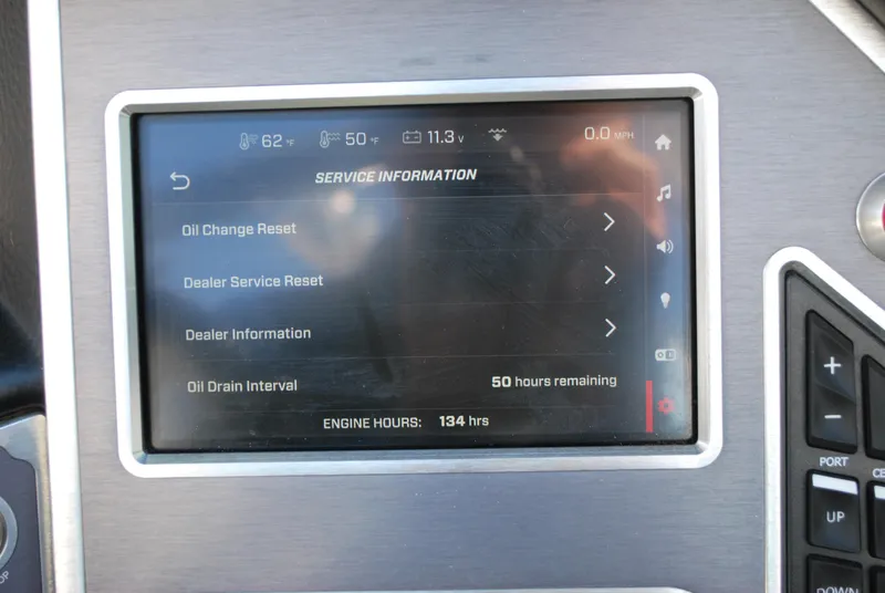 Slide: The Image of 2023 MasterCraft XT22 T dashboard displaying service information and oil change details. - 10