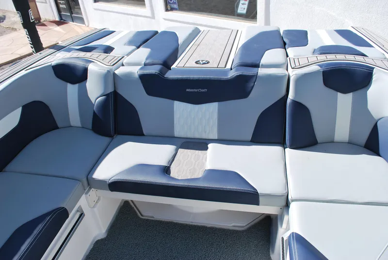 Slide: The Image of 2023 MasterCraft XT22 T boat interior with blue and gray seating. - 14