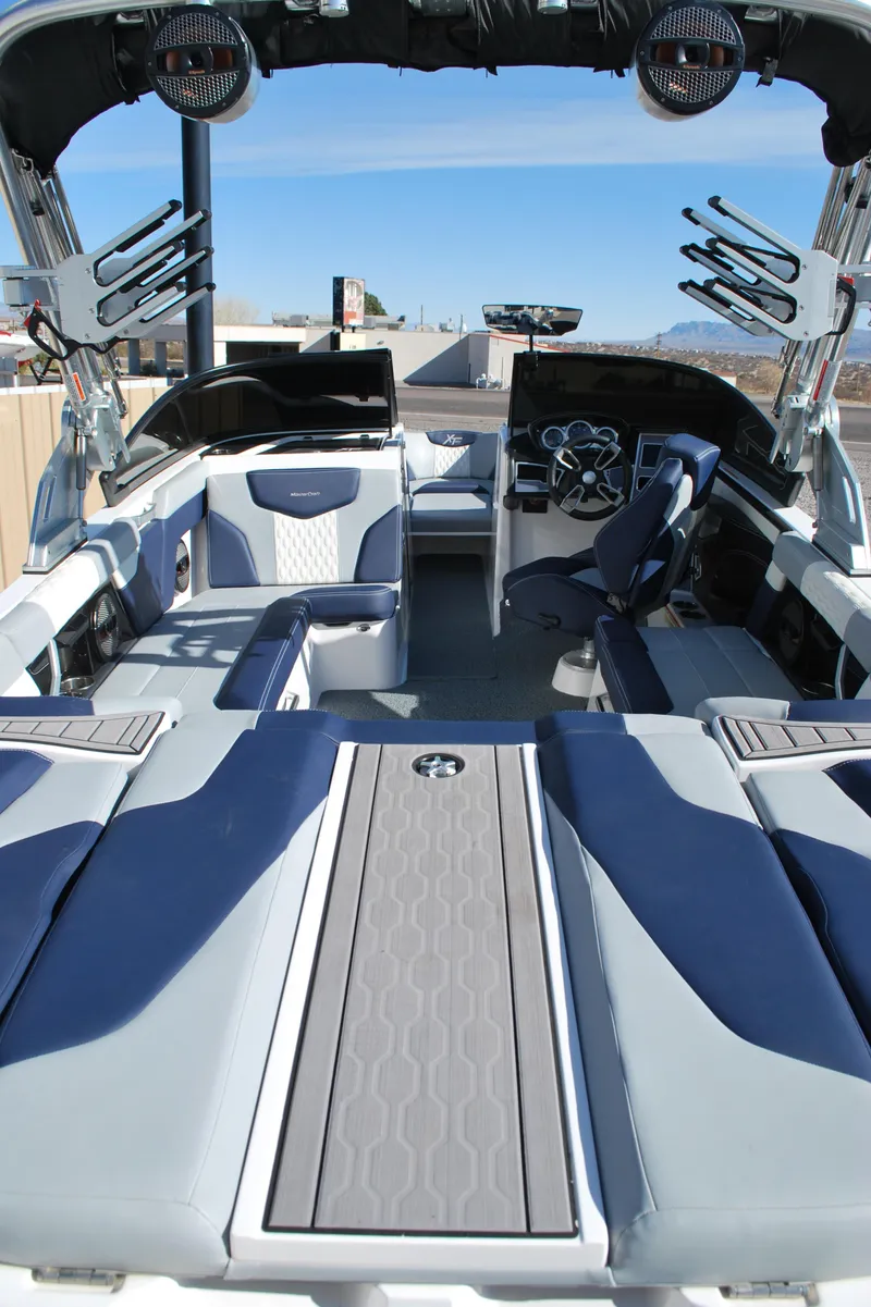 Slide: The Image of 2023 MasterCraft XT22 T boat interior with modern seating and sleek design. - 18