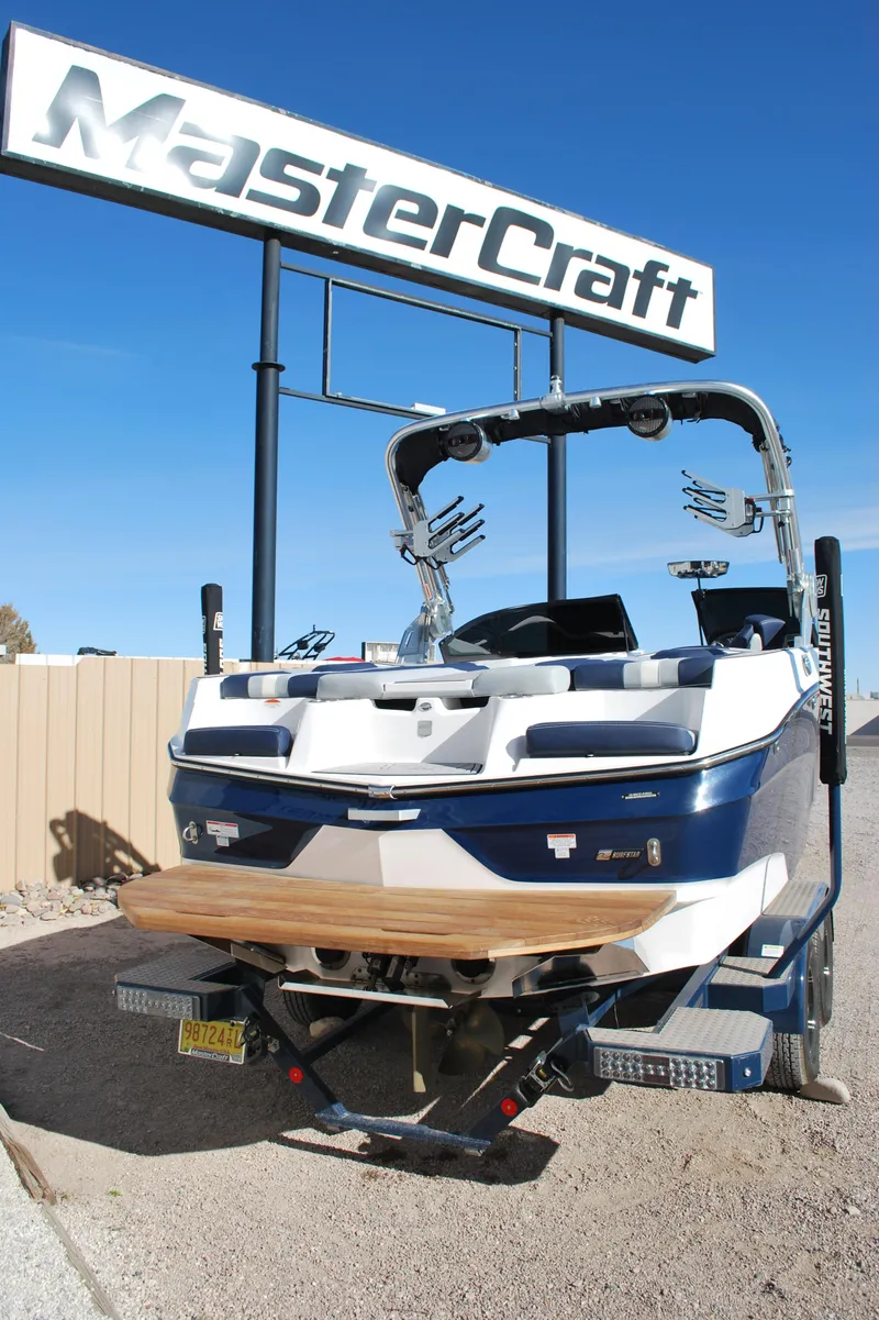 Slide: The Image of 2023 MasterCraft XT22 T boat displayed outdoors under a MasterCraft sign. - 20