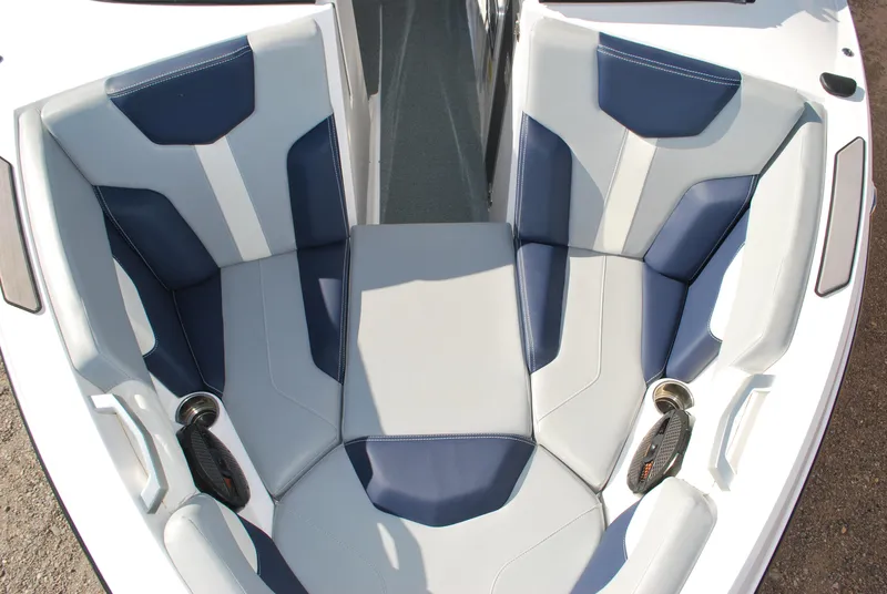 Slide: The Image of 2023 MasterCraft XT22 T boat interior with blue and gray seating. - 6
