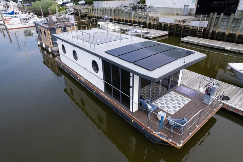 Slide: The Image of Modern 2025 Waterlodge Apart EL houseboat with solar panels docked at marina. - 10