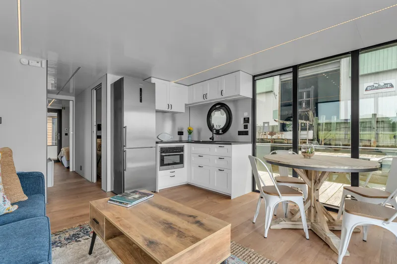 Slide: The Image of Modern Waterlodge Apart EL 2025 interior with sleek kitchen, dining area, and cozy living space. - 12