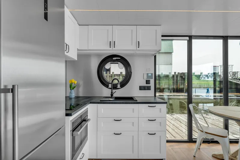 Slide: The Image of Modern kitchen in 2025 Waterlodge Apart EL, featuring sleek design and waterfront view. - 16