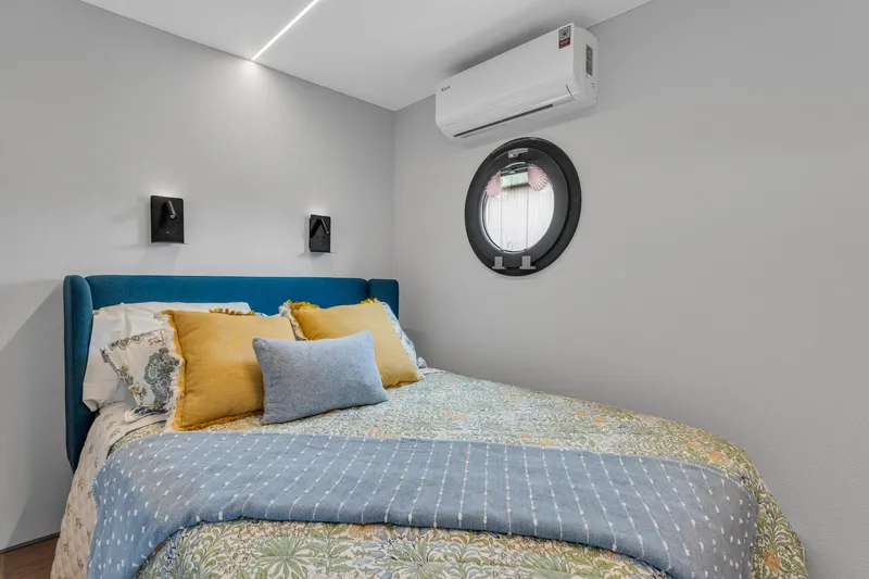 Slide: The Image of Cozy bedroom in 2025 Waterlodge Apart EL with modern decor and porthole window. - 17