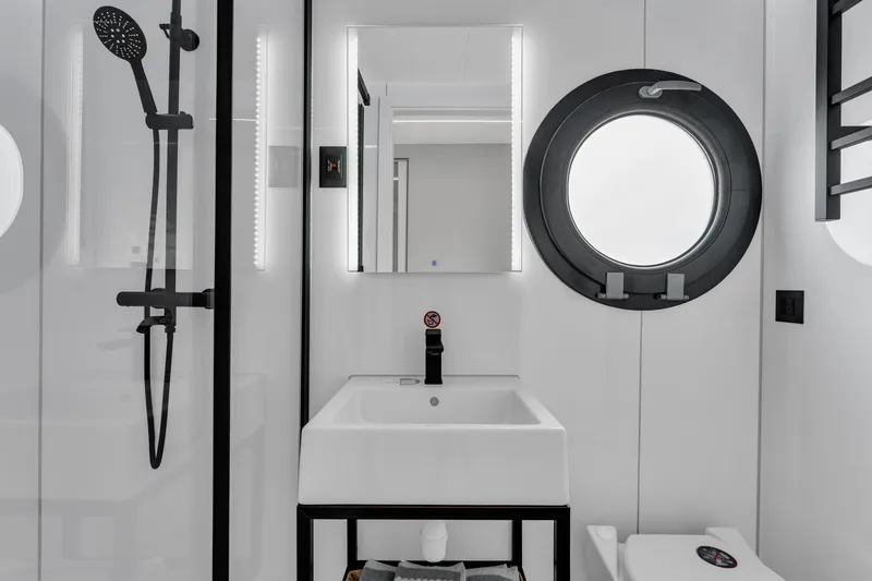 Slide: The Image of Modern bathroom in 2025 Waterlodge Apart EL with circular window and sleek fixtures. - 19