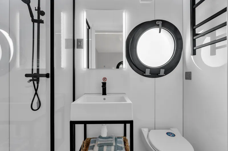 Slide: The Image of Modern bathroom in 2025 Waterlodge Apart EL with circular window and sleek fixtures. - 25