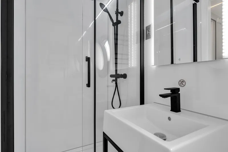 Slide: The Image of Modern bathroom in Waterlodge Apart EL 2025, featuring sleek shower and minimalist sink design. - 26
