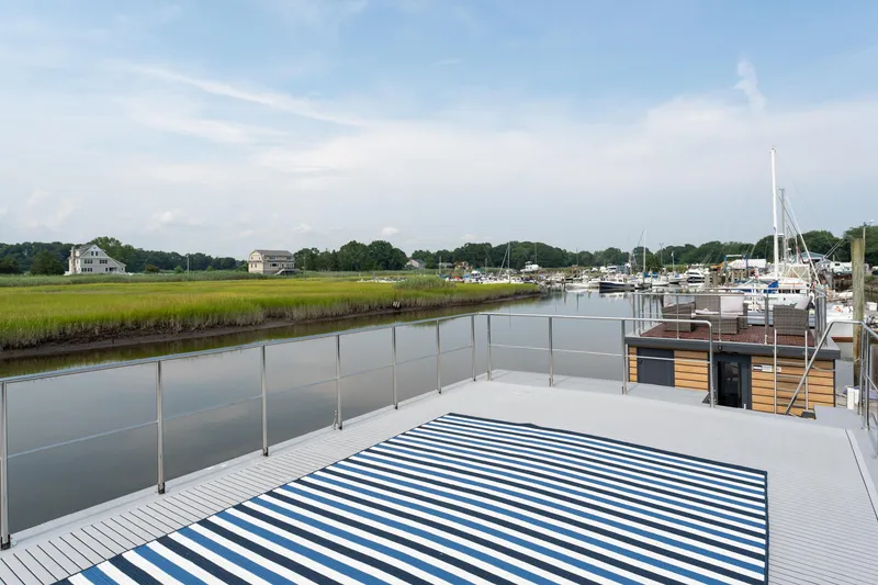 Slide: The Image of Rooftop view from 2025 Waterlodge Apart EL houseboat overlooking serene marina and lush landscape. - 31