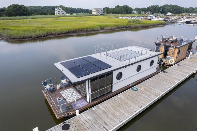Slide: The Image of Modern 2025 Waterlodge Apart EL houseboat with solar panels docked on a serene river. - 38