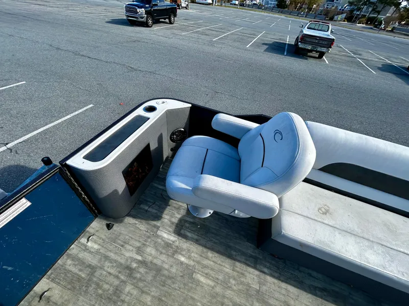 Slide: The Image of 2020 Crest Classic LX Fish 220 SF boat interior with seating in a parking lot. - 10