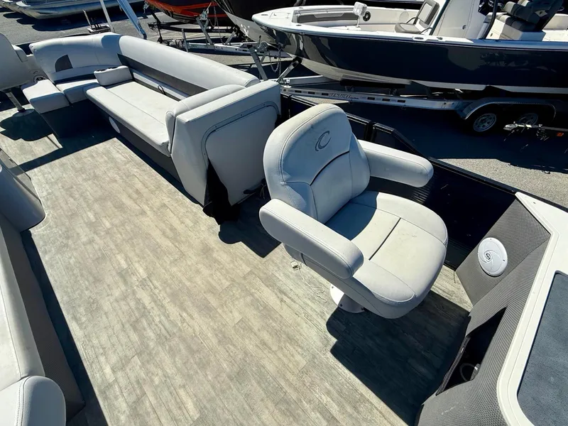 Slide: The Image of 2020 Crest Classic LX Fish 220 SF pontoon boat interior with seating and helm chair. - 12