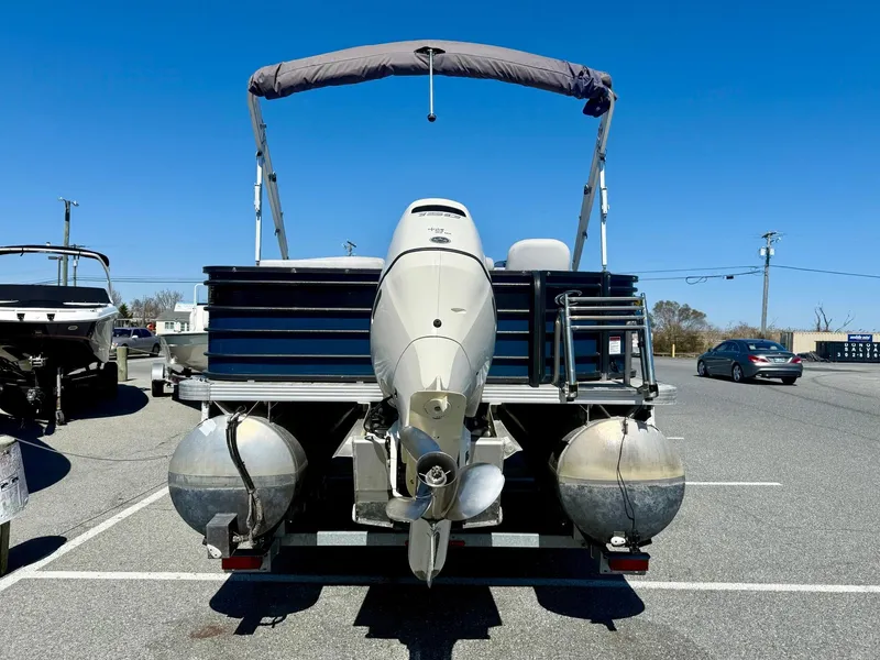 Slide: The Image of 2020 Crest Classic LX Fish 220 SF pontoon boat with outboard motor in parking lot. - 16