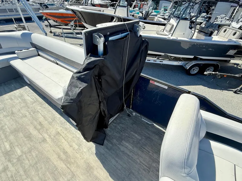 Slide: The Image of 2020 Crest Classic LX Fish 220 SF pontoon boat interior with seating and covered console. - 4