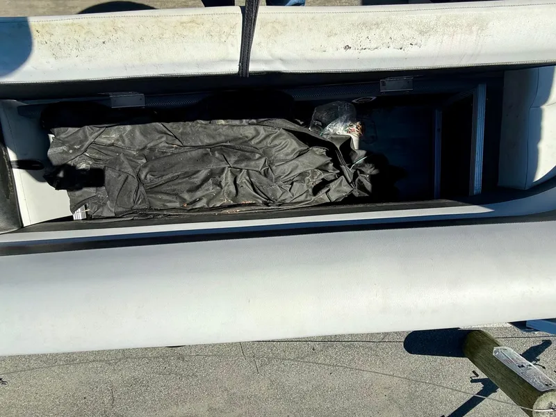 Slide: The Image of Storage compartment of 2020 Crest Classic LX Fish 220 SF boat, open with cover inside. - 5