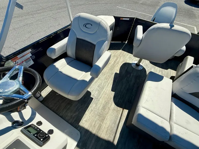 Slide: The Image of 2020 Crest Classic LX Fish 220 SF boat interior with steering wheel and seating. - 7