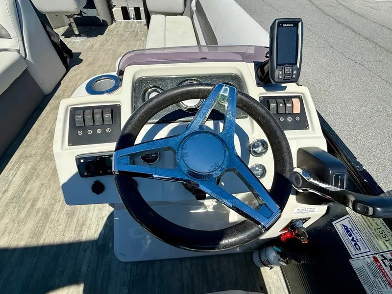 Slide: The Image of 2020 Crest Classic LX Fish 220 SF boat dashboard with steering wheel and controls. - 8