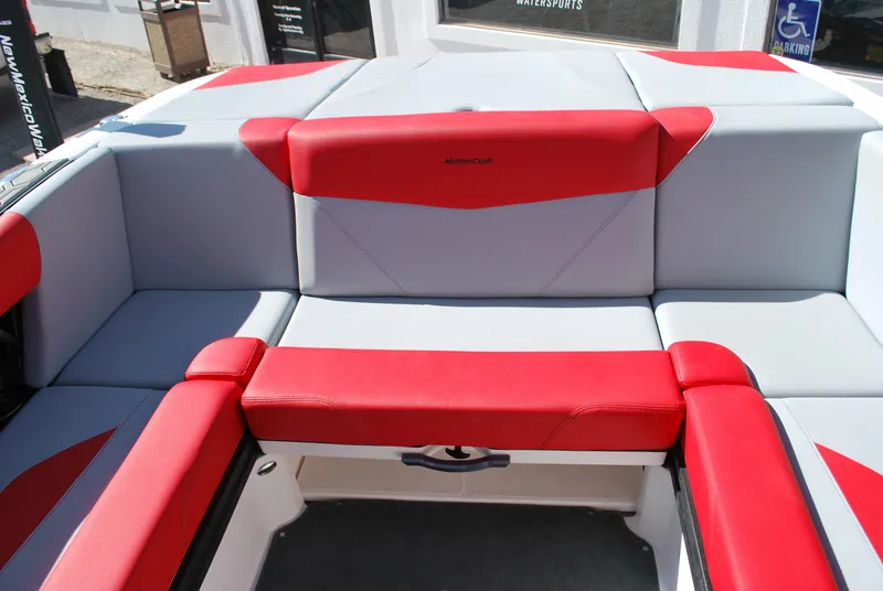Slide: The Image of 2022 MasterCraft NXT24 boat interior with red and gray seating. - 13