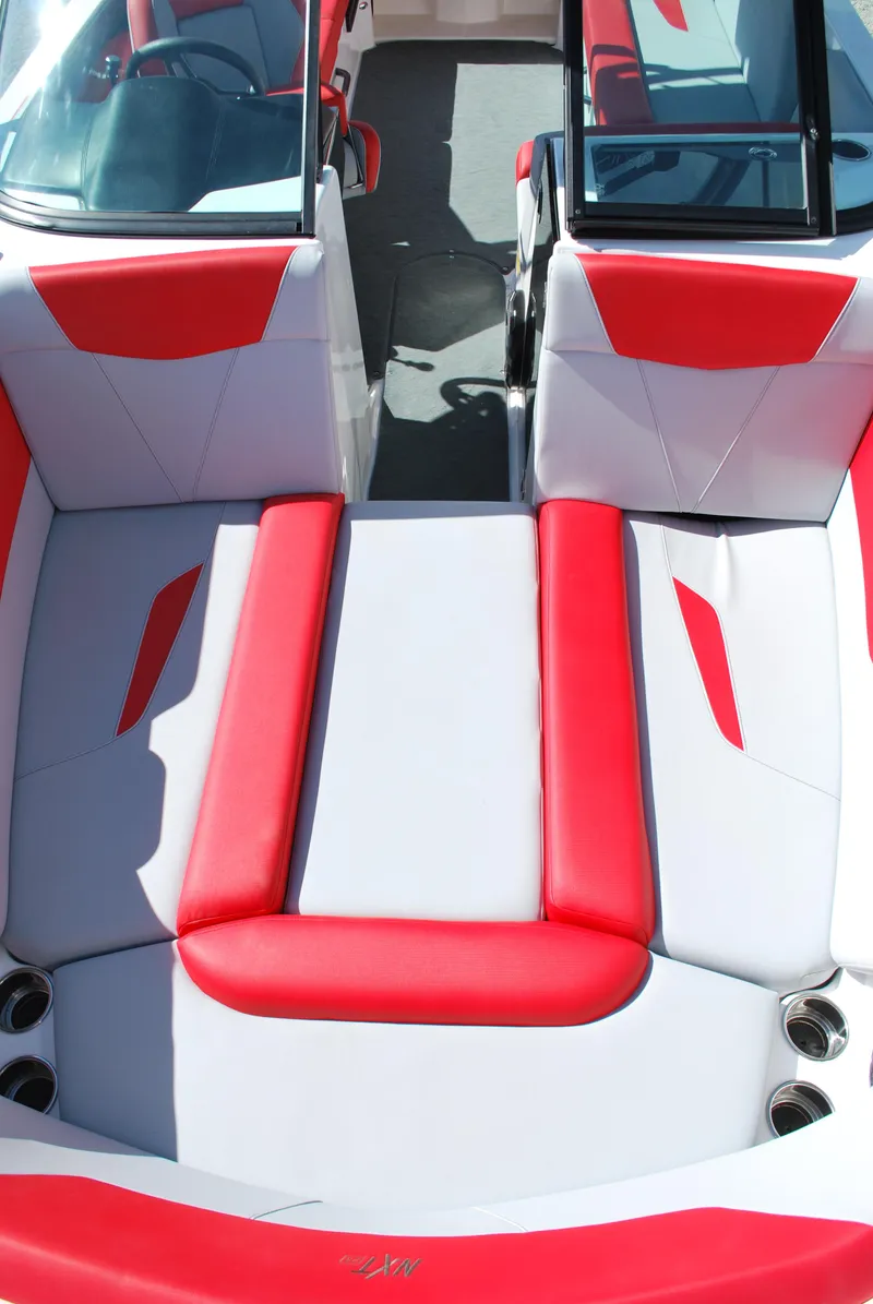 Slide: The Image of 2022 MasterCraft NXT24 boat interior with red and white seating. - 4