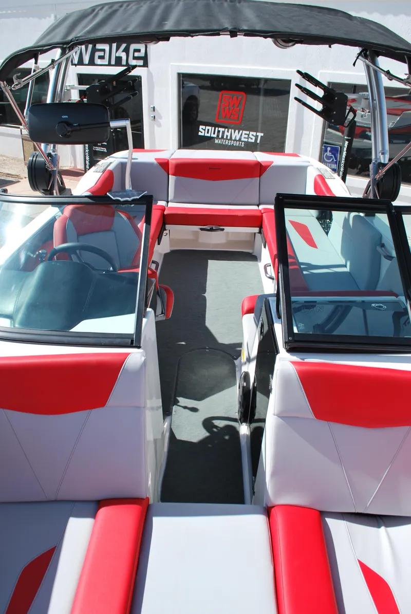 Slide: The Image of 2022 MasterCraft NXT24 boat interior with red and white seating, modern design. - 5