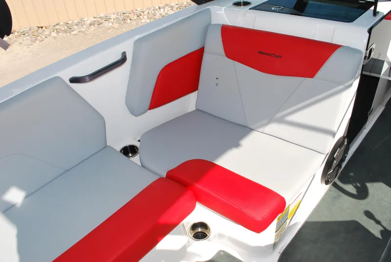 Slide: The Image of 2022 MasterCraft NXT24 boat interior with red and white seating. - 8