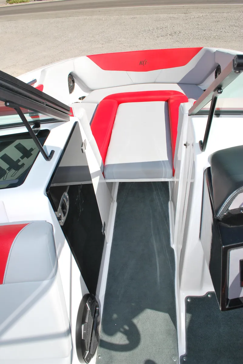 Slide: The Image of 2022 MasterCraft NXT24 boat interior with red and gray seating, open bow design. - 9