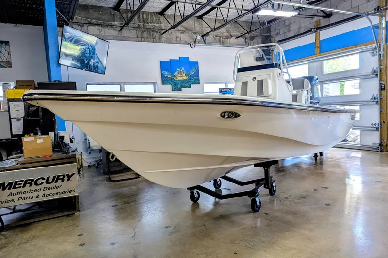 Slide: The Image of Frontier 2104 boat, 2025 model, displayed indoors on a wheeled stand. - 0