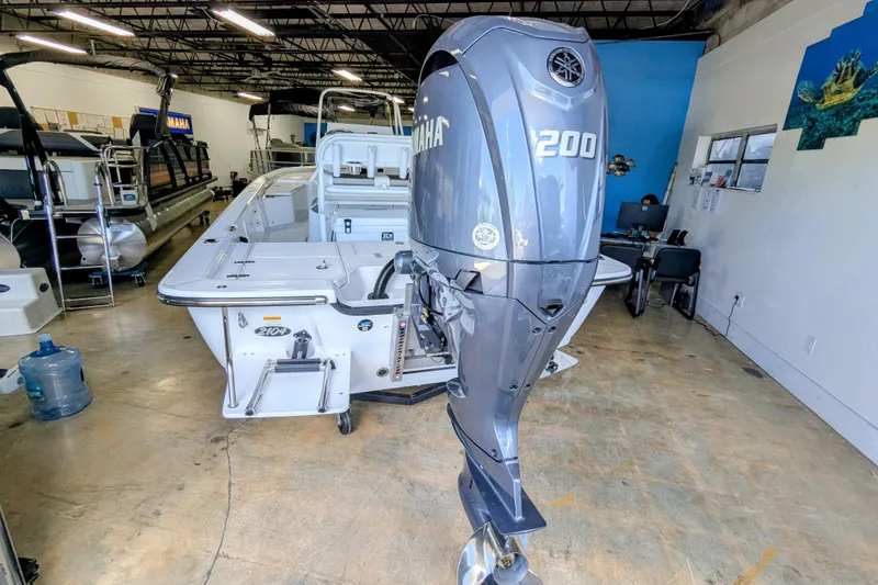 Slide: The Image of 2025 Frontier 2104 boat with Yamaha 200 outboard motor in showroom. - 1