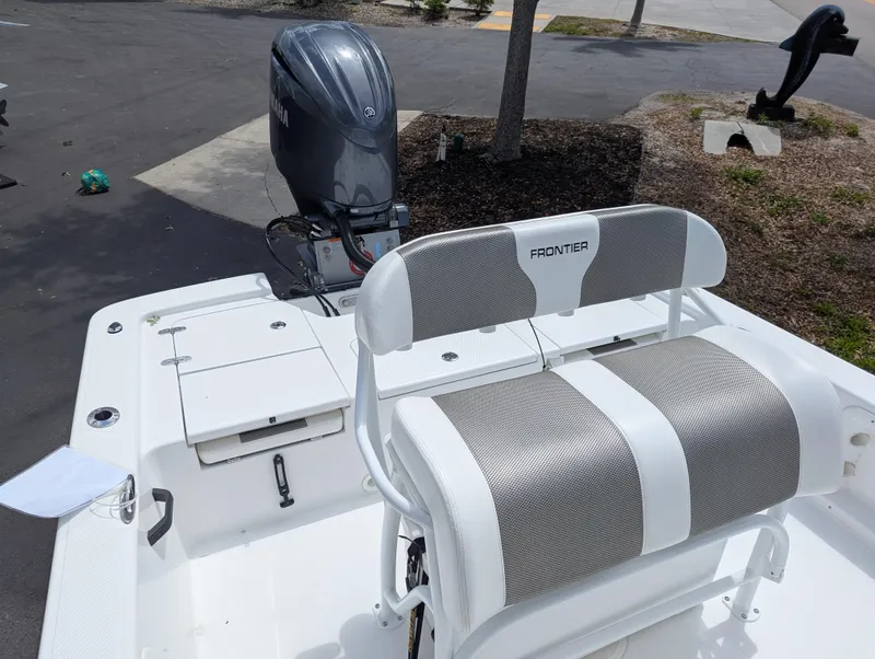 Slide: The Image of 2025 Frontier 2104 boat with Yamaha outboard motor, featuring a white and gray seating area. - 14