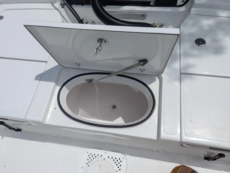 Slide: The Image of Open storage compartment on a 2025 Frontier 2104 boat deck. - 17